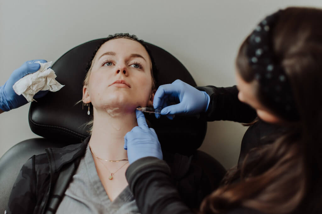 Needle being injected on Face | Wellness Co. | Zeeland, MI